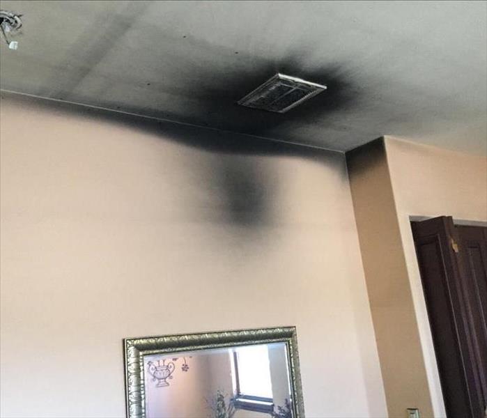 soot buildup by HVAC ceiling register, sooty walls